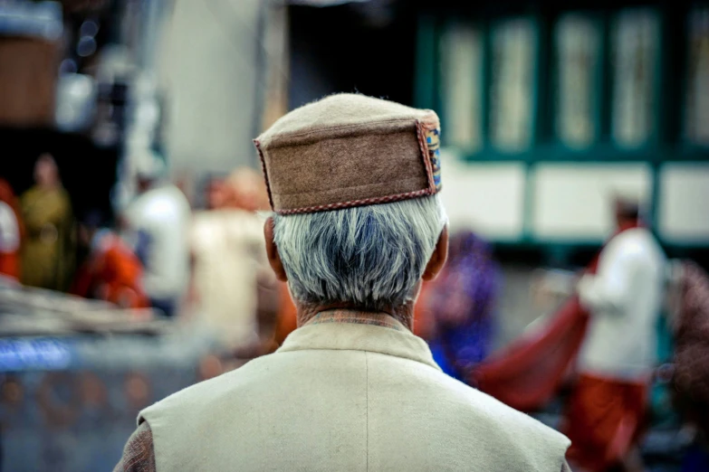 a old man wearing a hat and a cap