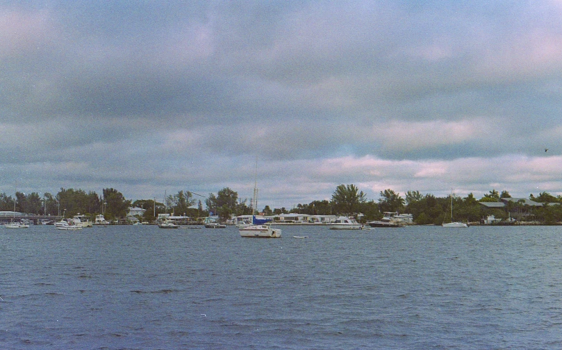 boats sit in the blue water of a harbor