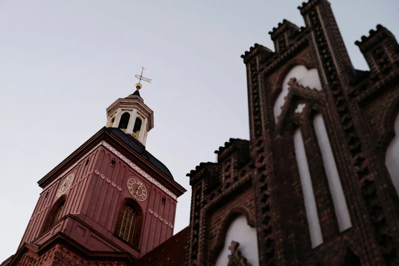 an old church steeple looks up into the sky