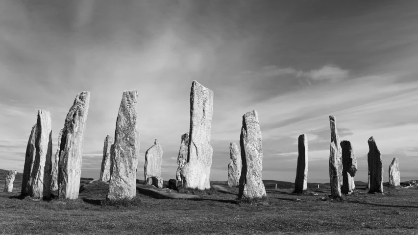 tall pillars sitting in the middle of an open field