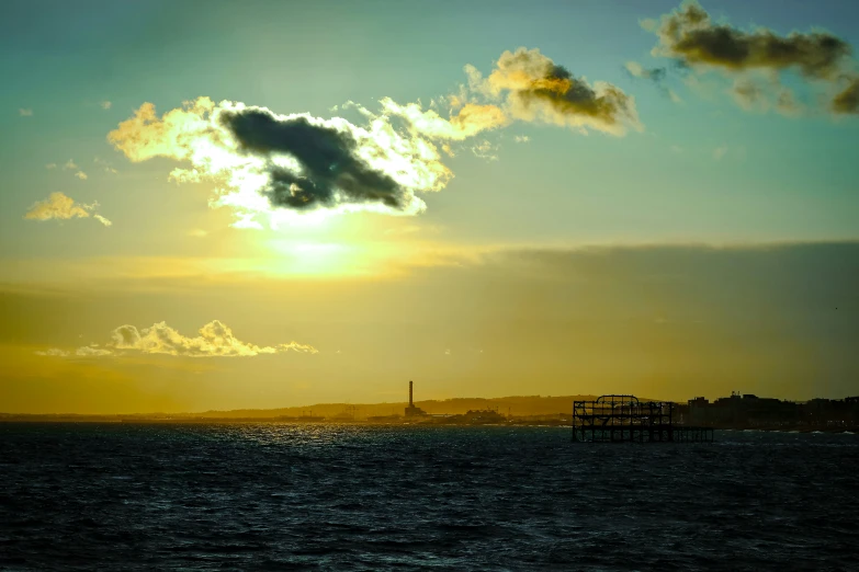 a large ship at sea as the sun sets