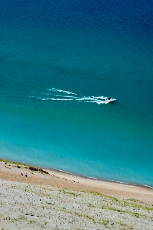 there is a boat out in the ocean water