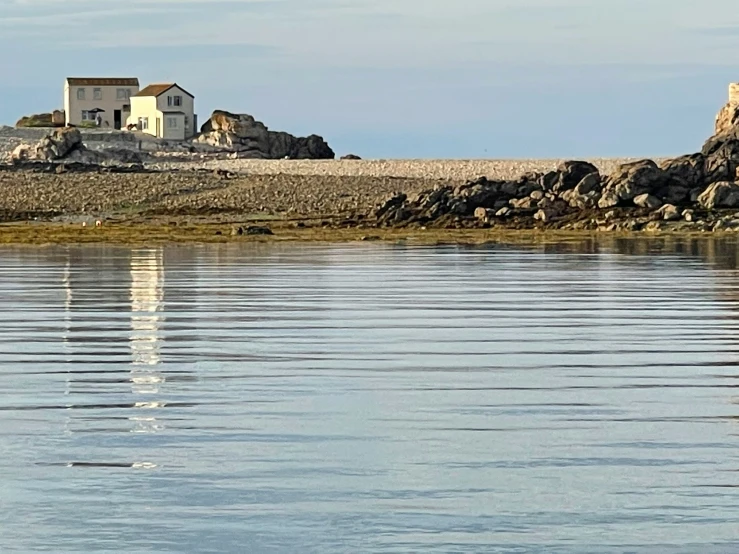 the house is on the island in the water