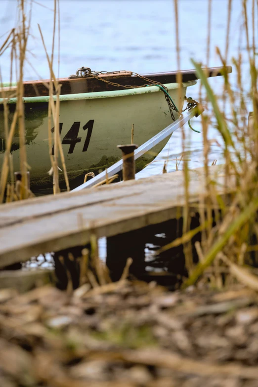 a small green boat sitting on top of the water