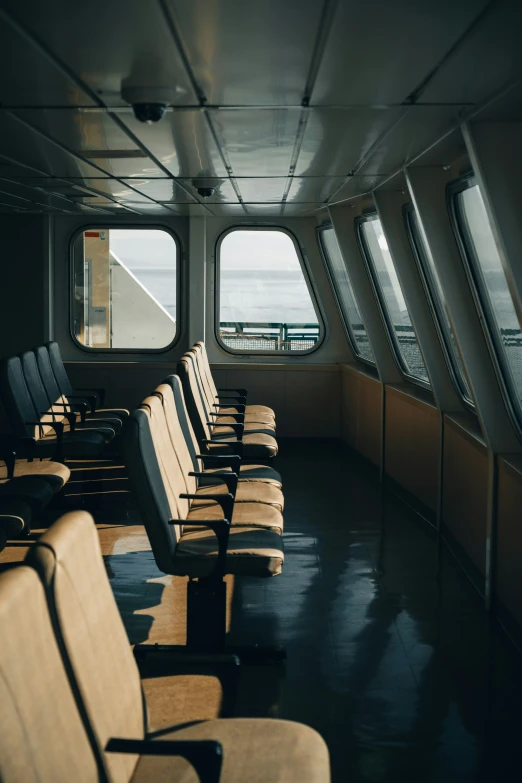 the inside of an old ferry with rows of chairs