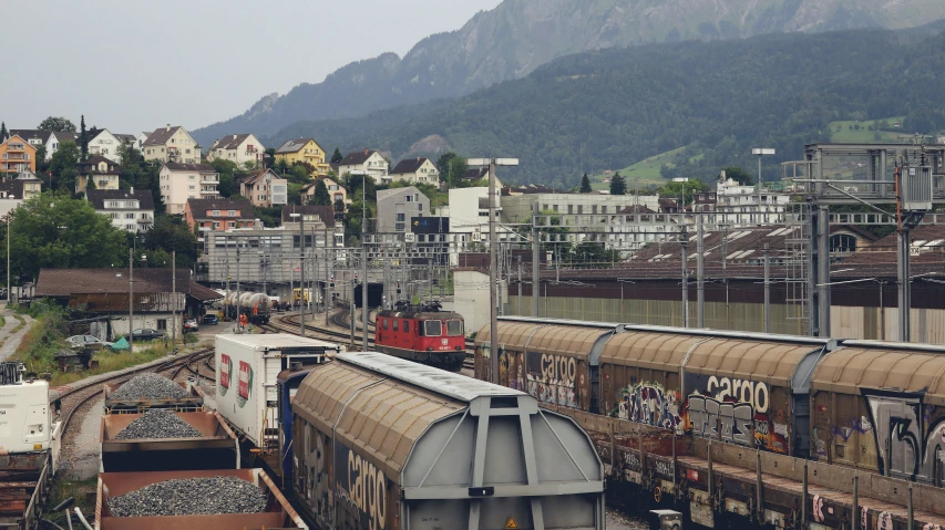 a red and white train engine pulling its cars on tracks