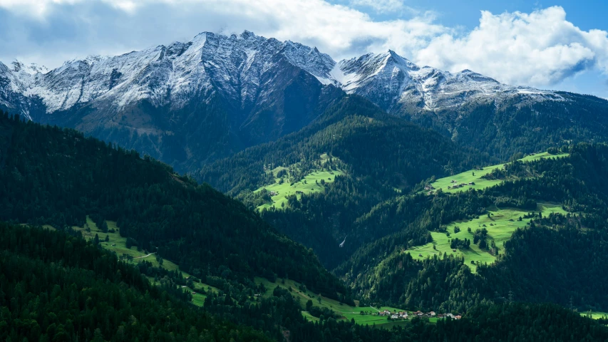 the mountains are covered with some green plants