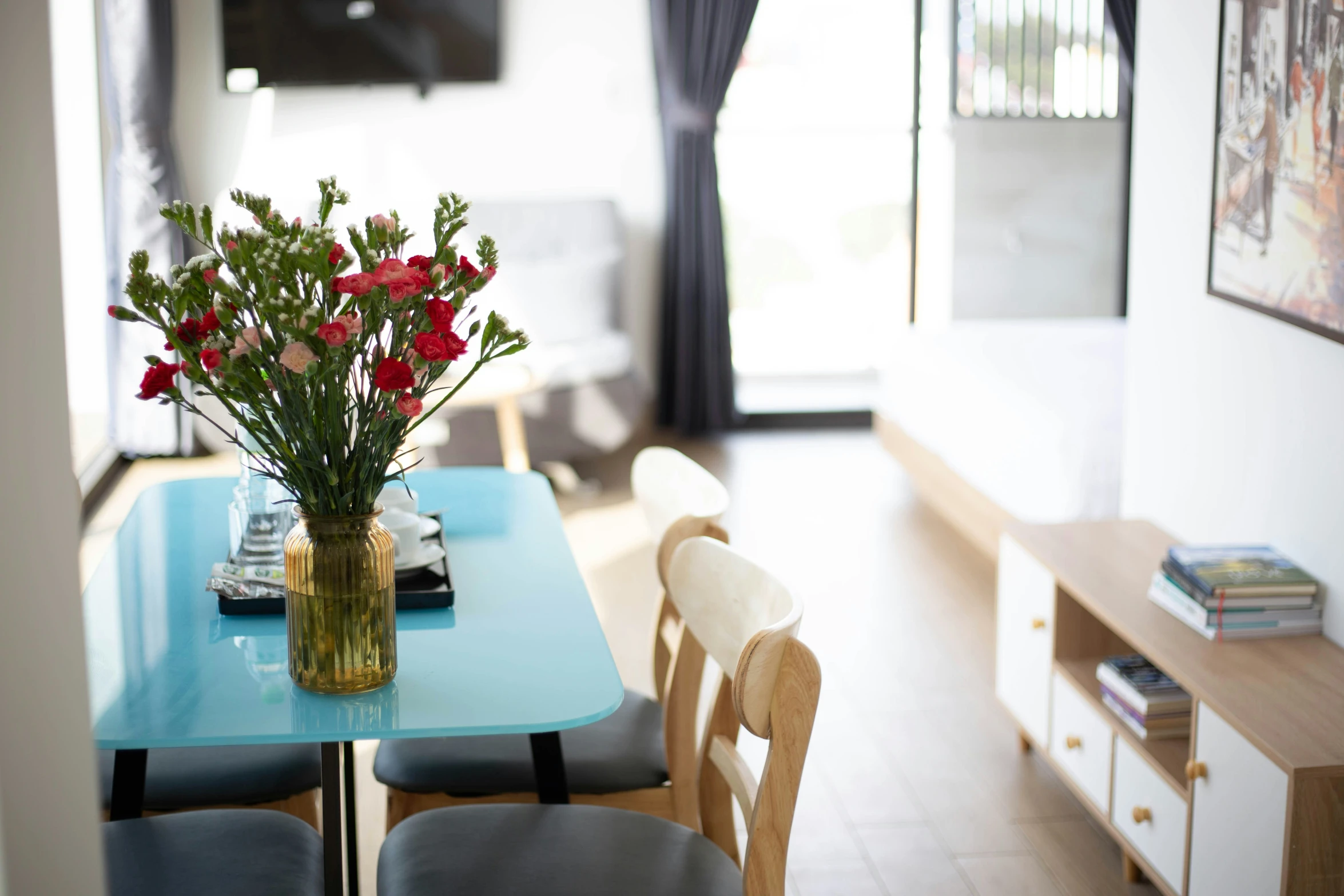 a vase filled with red flowers on a table