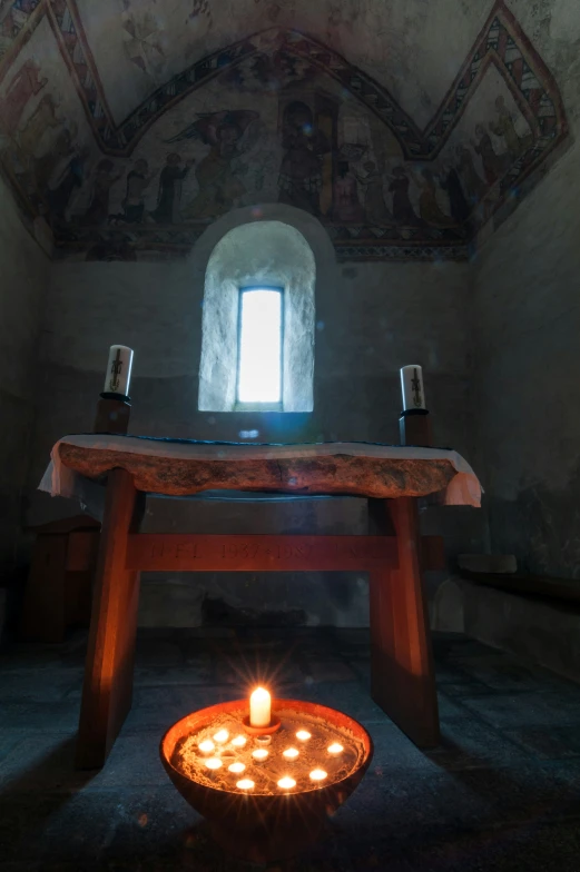 candles lit up in the center of a dark room