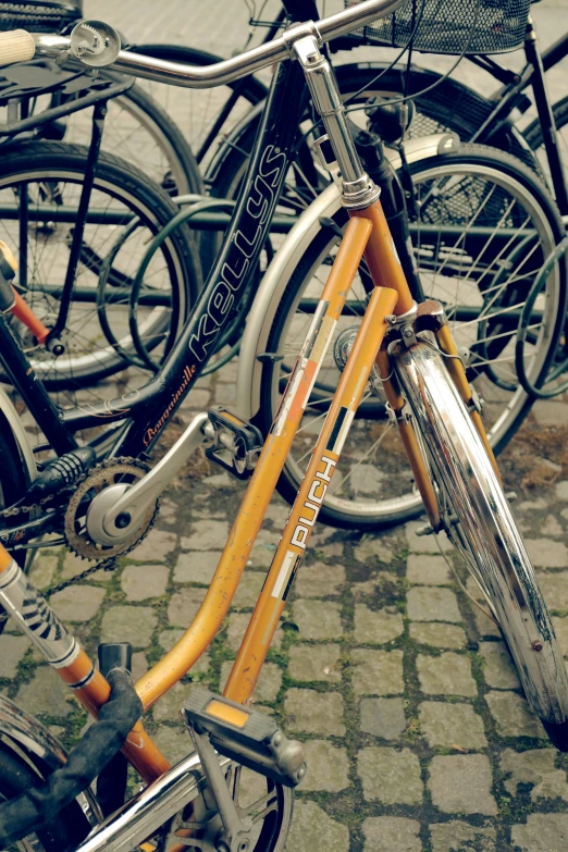 several bicycles parked in a parking lot together