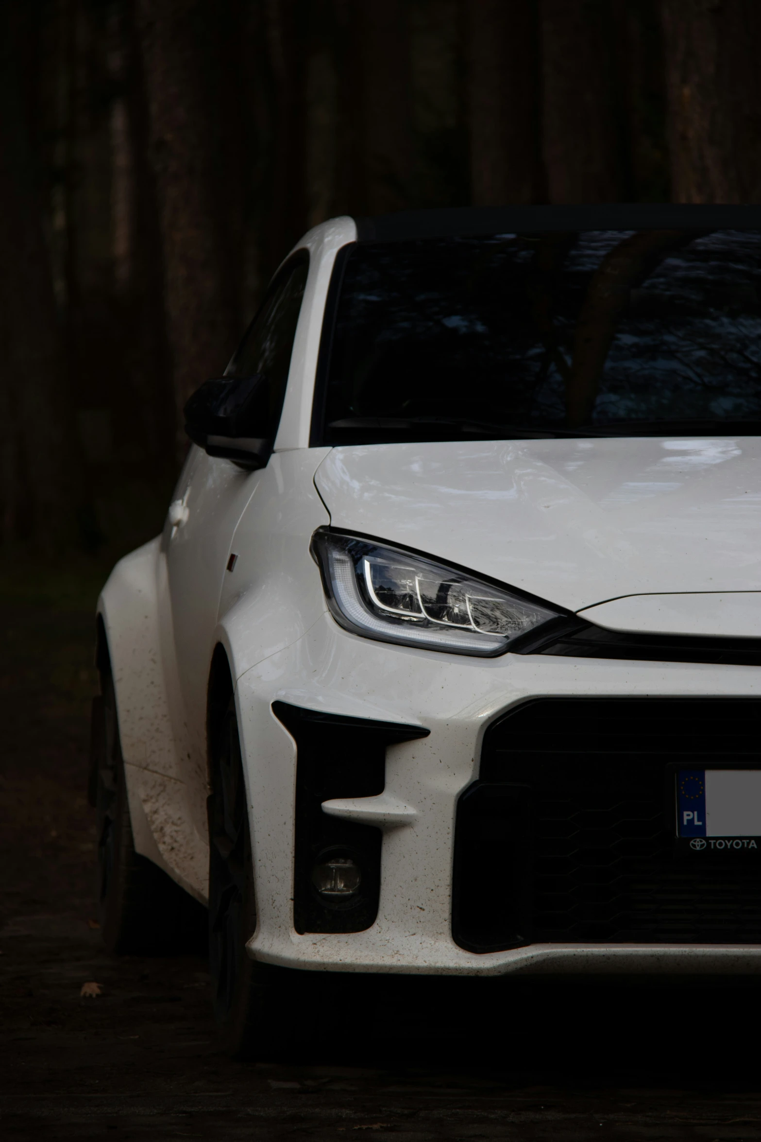 the front of a white sports car with it's hood up