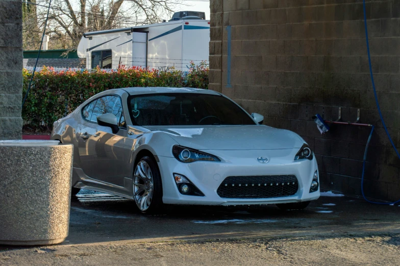 the toyota sports car is parked at an electrical outlet