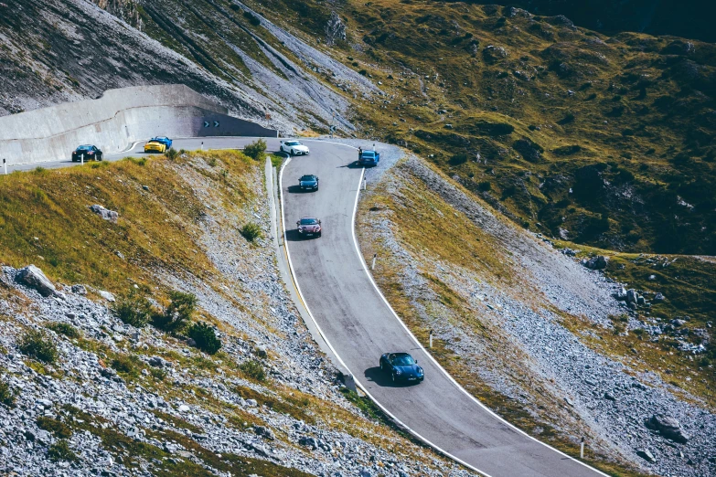 there are many vehicles on the road going up the side