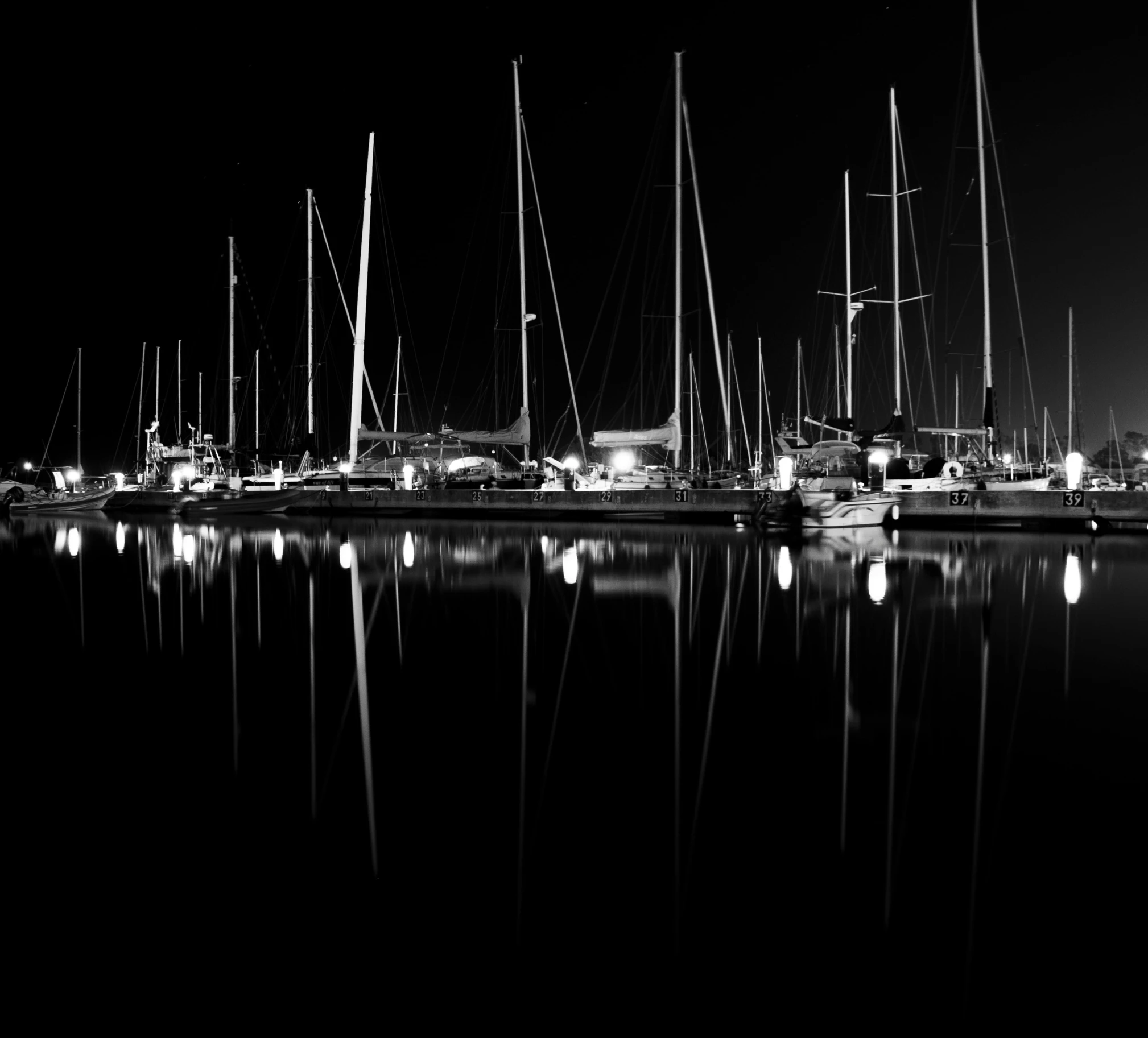 a bunch of sailboats sitting in the water