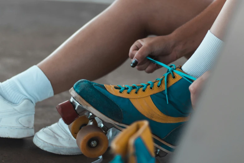 someone is tying a shoelace to their roller skate