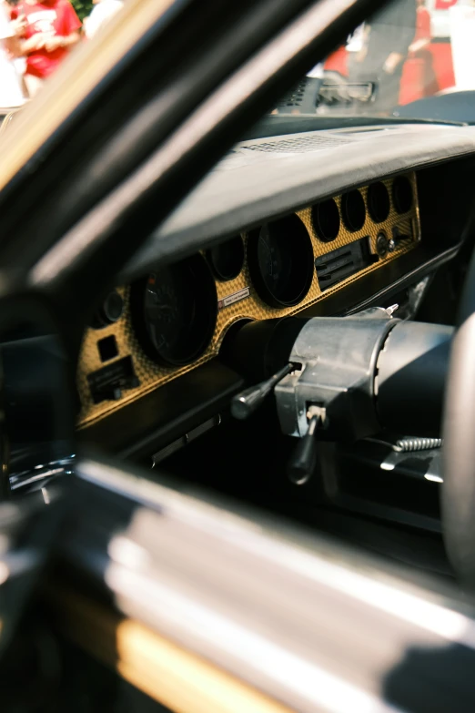 the dashboard of an old muscle car with its doors open