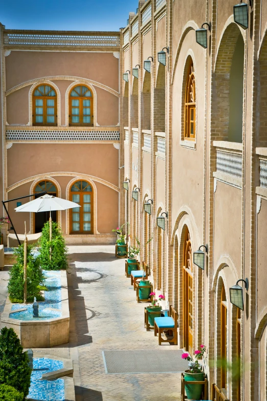 courtyard of el in oriental country setting with chairs and umbrella