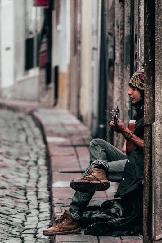 a man that is kneeling down playing guitar