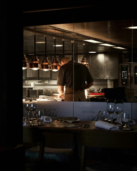 a person working in the kitchen behind the counter