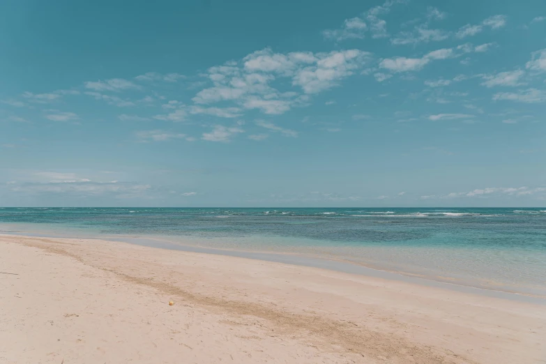 the blue waters and white sand of a beach