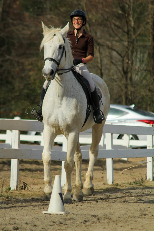 a person riding a horse behind a fence