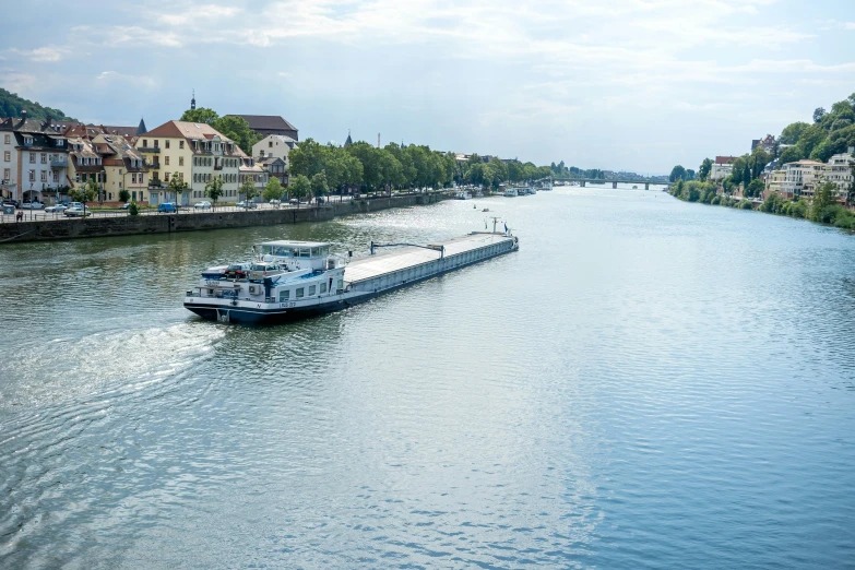 a boat floating down a river in front of homes