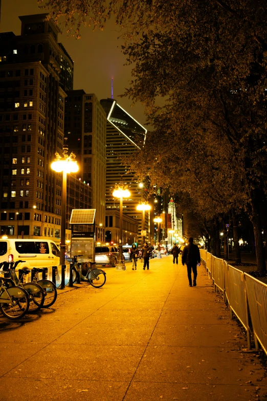 a busy street at night with a lot of people walking