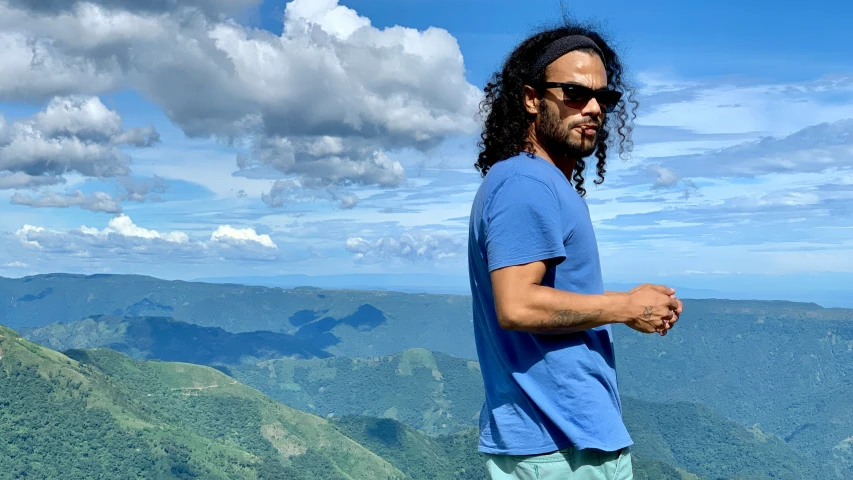 a man standing on a hill overlooking the landscape