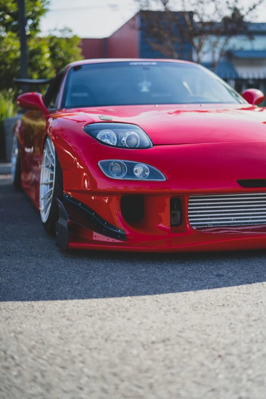 an image of red car parked in a parking lot