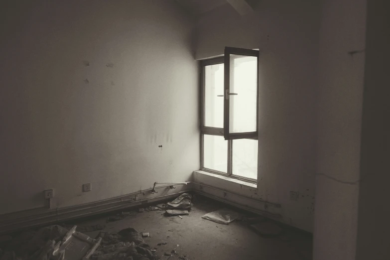 an empty room with a light coming through the window