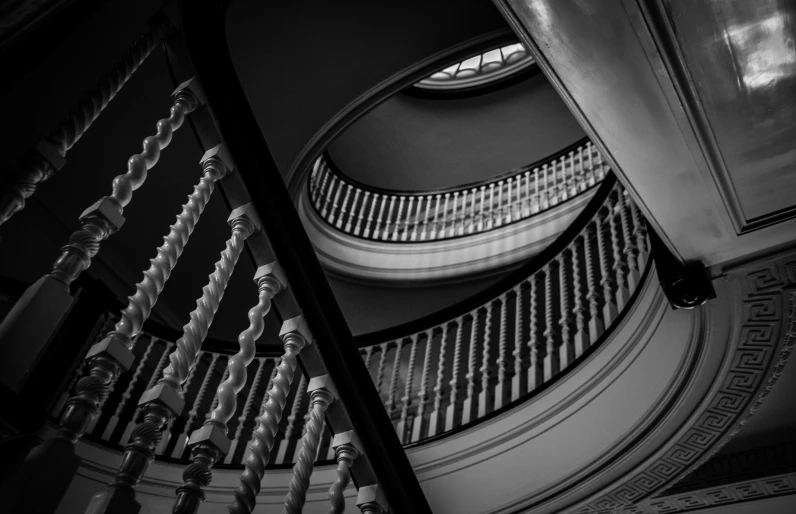 a spiral staircase is next to a very tall building