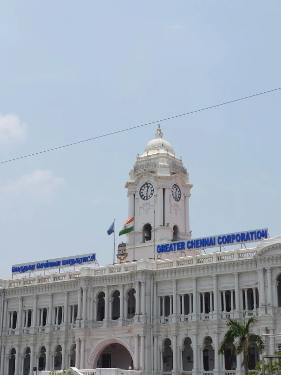 an official building with a tall clock tower in the background