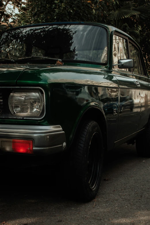 an old car with it's headlight on and the windows showing