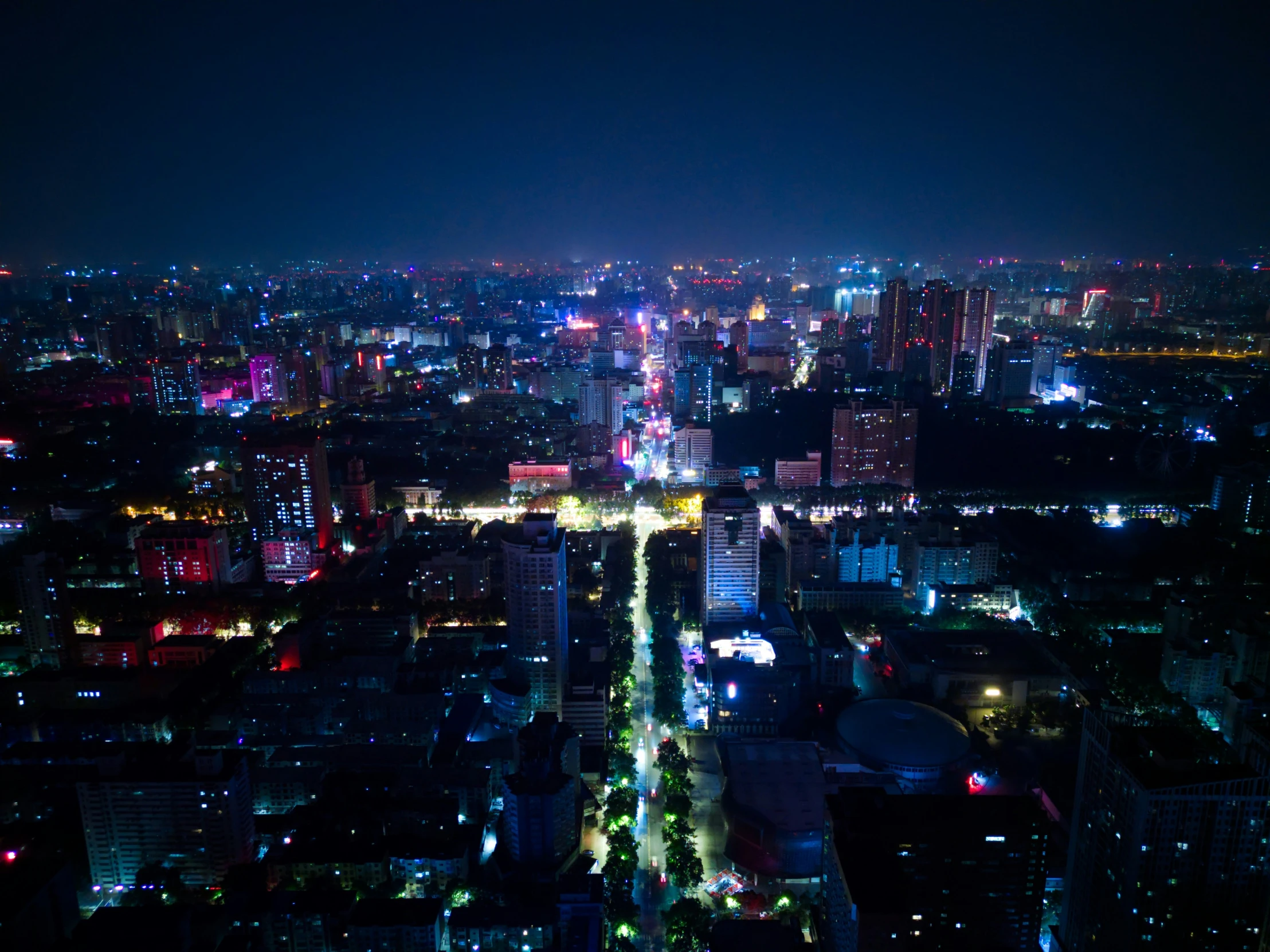 a nighttime view of a large city from above