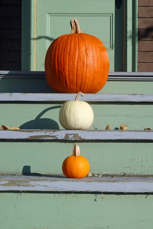 an image of two pumpkins sitting on steps