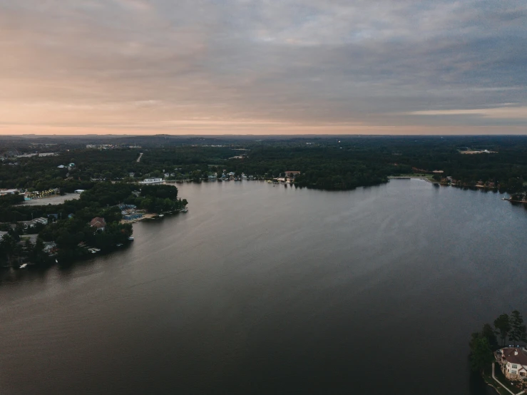 an aerial view of the water and trees on either side