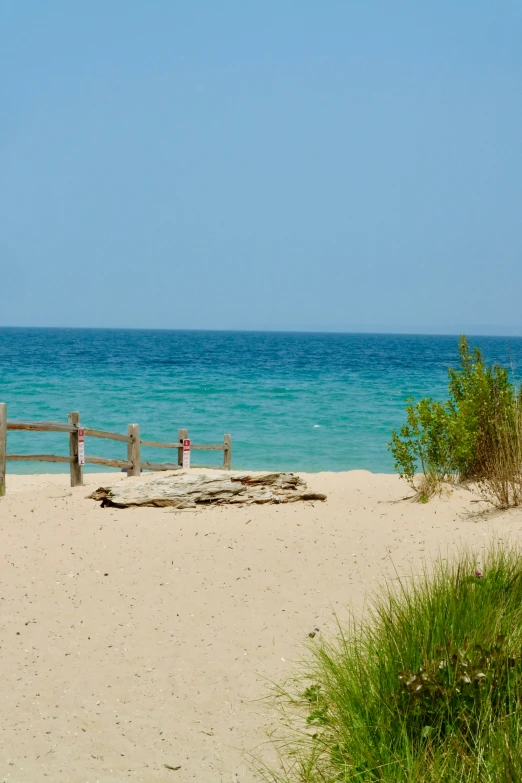 a beach area with some water and a fence