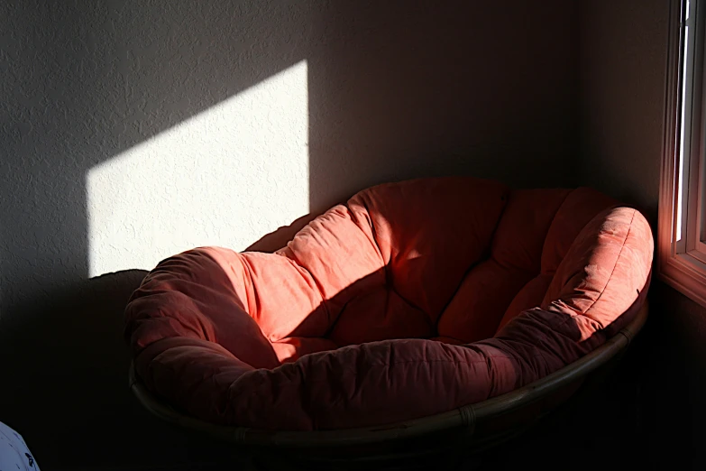 the small round bed is against a gray wall