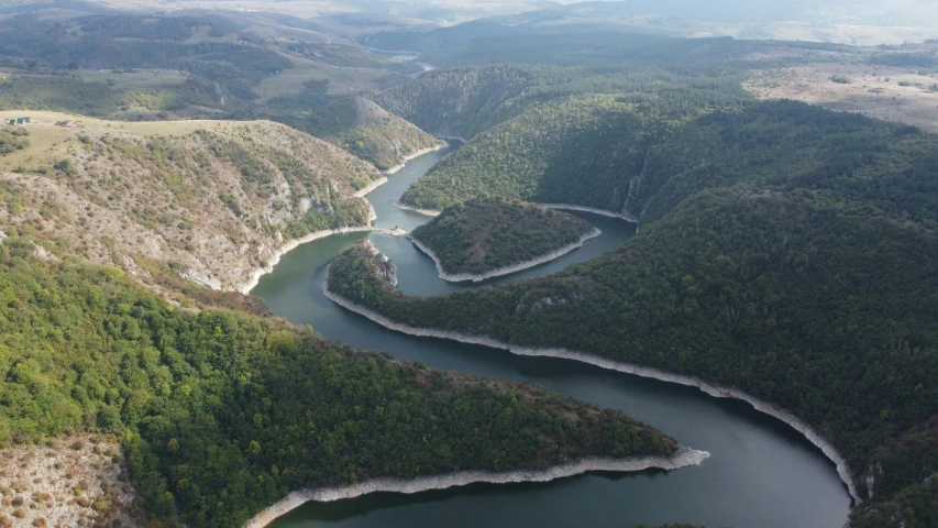 an aerial view of a river running through a valley