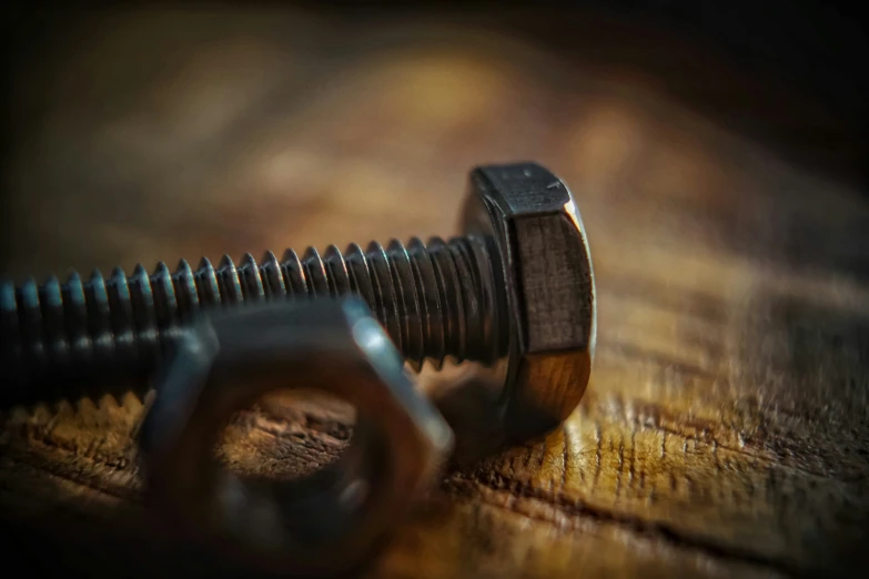 a close up view of a screw and a piece of metal