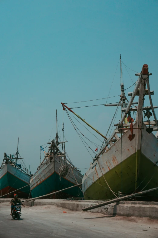 multiple boats docked in dry land with one boat on the opposite side