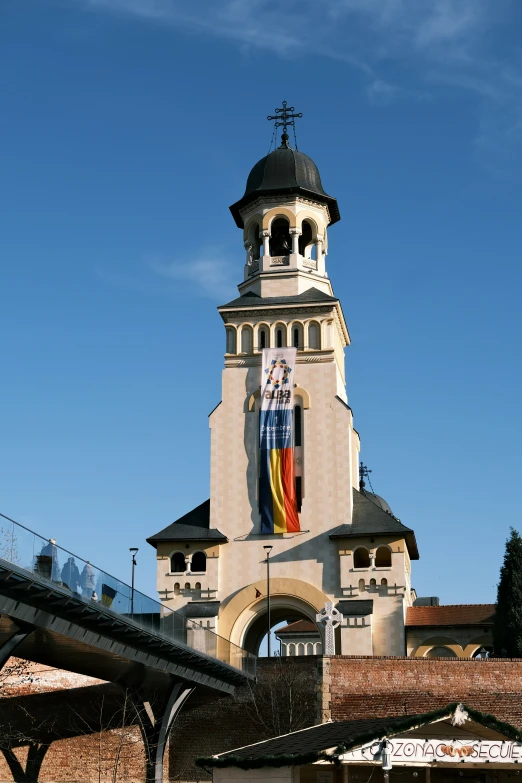 the tower has an arched doorway and a colorful clock at the top