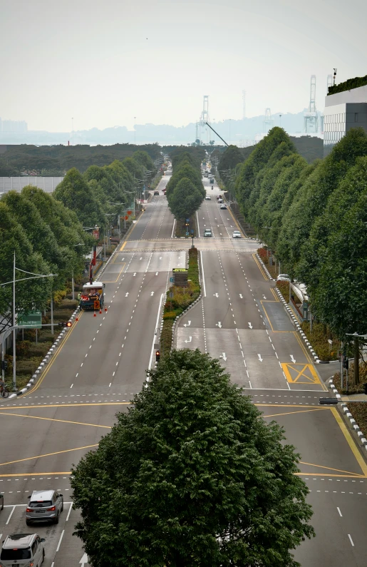 a street with lots of cars driving on it and an overpass