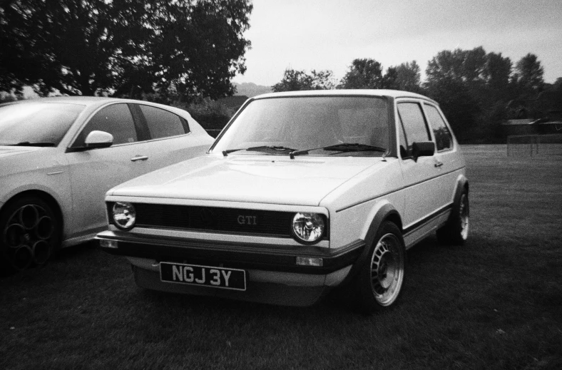 a black and white po of two older cars