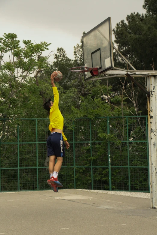 a person jumping up in the air to dunk a basketball