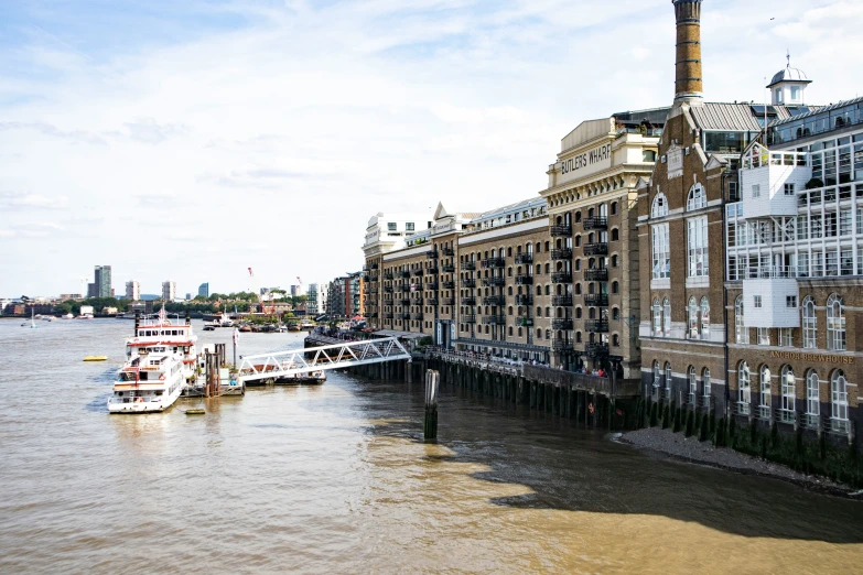 boats that are floating along the side of a building