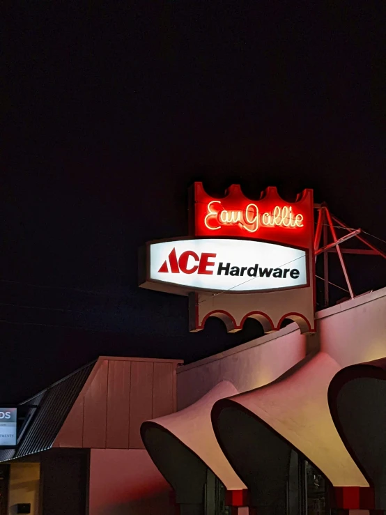 a neon sign with the ace hardware lit up