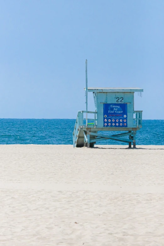 a lifeguard hut next to the ocean on a beach