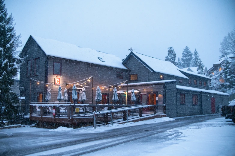 a snow covered building on the side of a road