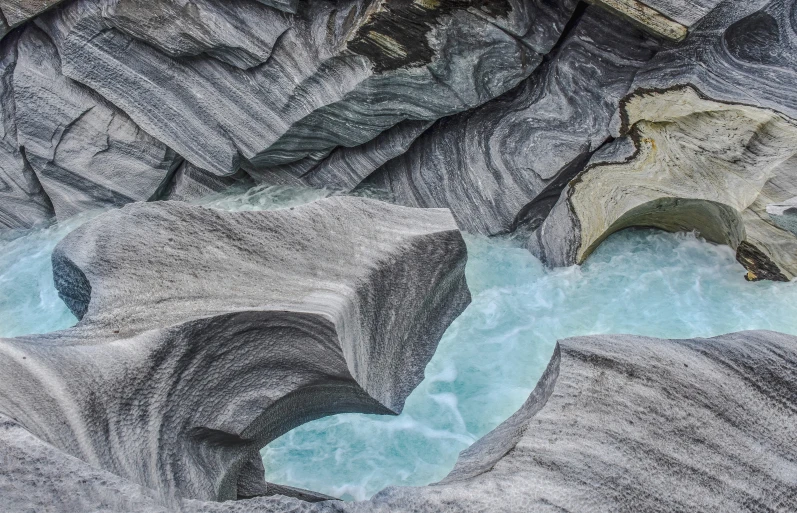 a view from above, of a river that is surrounded by rocks